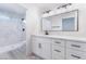 Modern bathroom featuring a walk-in shower with marble-look tile and double sinks at 2553 Showcase Dr, Las Vegas, NV 89134
