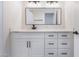 Elegant bathroom featuring a white vanity with black hardware and a large rectangular mirror at 2553 Showcase Dr, Las Vegas, NV 89134