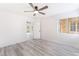 Bright bedroom with wood-look floors, ceiling fan, and a window for natural light at 2553 Showcase Dr, Las Vegas, NV 89134