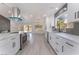 Contemporary kitchen with stainless steel appliances, white cabinets, sleek countertops, and light wood grain floors at 2553 Showcase Dr, Las Vegas, NV 89134