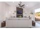 Virtually staged living room featuring a fireplace, floating shelves, and stylish furniture at 2553 Showcase Dr, Las Vegas, NV 89134