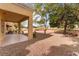 Charming covered patio overlooking a well-maintained yard with lush landscaping at 2553 Showcase Dr, Las Vegas, NV 89134