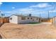 Backyard features a sand-covered area, small patch of artificial grass, and white gravel along the side of the home at 2721 Bruce Cir, North Las Vegas, NV 89030