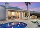 Back patio featuring dining and seating areas, outdoor kitchen, and pool access for the ultimate entertainment at 2768 Tyndrum Ave, Henderson, NV 89044
