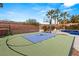 Home basketball court featuring branded design and proximity to a sparkling pool with lush palm trees at 2768 Tyndrum Ave, Henderson, NV 89044