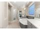 Bright bathroom with a walk-in shower, soaking tub, and light tile flooring at 2768 Tyndrum Ave, Henderson, NV 89044