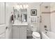 Bathroom featuring a vanity, modern fixtures, and a shower-tub combo with tiled walls at 2768 Tyndrum Ave, Henderson, NV 89044