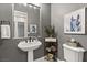 Elegant powder room features pedestal sink, decorative mirror and stylish gray paint at 2768 Tyndrum Ave, Henderson, NV 89044