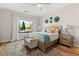 Bright bedroom with a king bed, decorative pillows, side tables, and a view of the mountains at 2768 Tyndrum Ave, Henderson, NV 89044