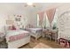 Bright bedroom with two beds, a desk area, and soft pink accents creating a warm and inviting space at 2768 Tyndrum Ave, Henderson, NV 89044