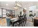 Elegant dining room with modern light fixture and sliding doors to outdoor area at 2768 Tyndrum Ave, Henderson, NV 89044