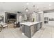Open kitchen with island seating, stainless steel appliances, and modern design elements at 2768 Tyndrum Ave, Henderson, NV 89044
