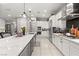 Bright, modern kitchen with white cabinetry, stainless steel appliances, and an expansive island at 2768 Tyndrum Ave, Henderson, NV 89044