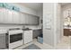 Well-equipped laundry room with ample cabinet space and modern washer and dryer at 2768 Tyndrum Ave, Henderson, NV 89044