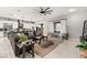 Open-concept living room features a modern kitchen, a spacious seating area, and plenty of natural light at 2768 Tyndrum Ave, Henderson, NV 89044