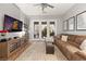Inviting living room featuring a plush sectional sofa, large screen tv, and access to the outdoor patio at 2768 Tyndrum Ave, Henderson, NV 89044