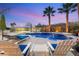 Relaxing pool and spa area with lounge chairs and palm trees, perfect for enjoying the backyard at 2768 Tyndrum Ave, Henderson, NV 89044