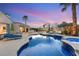 Inviting backyard pool and spa with basketball court, seating area, and lush landscaping offers an outdoor oasis at 2768 Tyndrum Ave, Henderson, NV 89044