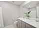 Bright bathroom featuring a double sink vanity, gray cabinets and tile flooring at 2816 Turnstone Ridge St, Henderson, NV 89044