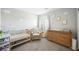 Cozy Bedroom with a crib, armchair, and changing table at 2816 Turnstone Ridge St, Henderson, NV 89044