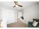 Bedroom with closet, ceiling fan, and green accent chair at 2816 Turnstone Ridge St, Henderson, NV 89044