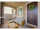 Inviting front porch with stylish seating area and charming decor for a welcoming entrance at 2816 Turnstone Ridge St, Henderson, NV 89044
