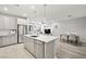 Bright kitchen with stainless appliances, white countertops, and an open layout to the living room at 2816 Turnstone Ridge St, Henderson, NV 89044