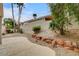 Landscaped backyard with patio, rock feature, shrubbery and several palm trees at 2944 Carmelo Dr, Henderson, NV 89052