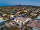 Scenic aerial view of a well-maintained community with lush landscaping, mountains, and desert, perfect for peaceful living at 3002 Hickory Valley Rd, Henderson, NV 89052