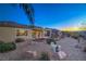 Backyard with desert landscaping including gravel, fountain, palm tree, and small seating area at 3002 Hickory Valley Rd, Henderson, NV 89052