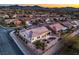 Backyard view with desert landscaping, cozy covered patio, and captivating mountain views at 3002 Hickory Valley Rd, Henderson, NV 89052