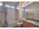 Bathroom featuring a shower-tub combo with a curtain, toilet, and vanity with stone countertops at 3002 Hickory Valley Rd, Henderson, NV 89052