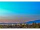 Expansive views of the city skyline and surrounding mountains at dusk at 3002 Hickory Valley Rd, Henderson, NV 89052