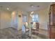Bright dining room featuring a modern glass table, stylish chairs, and elegant marble flooring at 3002 Hickory Valley Rd, Henderson, NV 89052