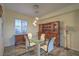 Dining room showcasing a modern glass table with stylish chairs and an elegant wooden hutch at 3002 Hickory Valley Rd, Henderson, NV 89052