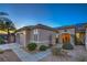 Side view of a well-maintained home featuring manicured landscaping, a two-car garage and covered entry at 3002 Hickory Valley Rd, Henderson, NV 89052