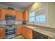 Efficient kitchen with granite countertops, stainless appliances, and ample storage, and a window over the sink at 3002 Hickory Valley Rd, Henderson, NV 89052