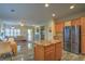 Bright open living space with kitchen island, fireplace, and sliding glass doors for indoor-outdoor flow at 3002 Hickory Valley Rd, Henderson, NV 89052