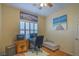 Office area features a desk, daybed, and shutters on the window at 3002 Hickory Valley Rd, Henderson, NV 89052