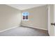 Well-lit bedroom with carpeting, neutral paint, and a large window at 317 E Van Wagenen St, Henderson, NV 89015
