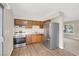 Traditional kitchen with stainless steel appliances and wood cabinets, offering a functional cooking space at 317 E Van Wagenen St, Henderson, NV 89015