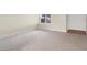 Spacious living room with neutral carpeting and a bright window allowing natural light at 317 E Van Wagenen St, Henderson, NV 89015