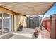 Covered patio area featuring a storage shed and brick accents, ideal for outdoor living at 317 E Van Wagenen St, Henderson, NV 89015