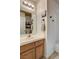 Well-lit bathroom featuring a wood vanity with a sink and a mirror, complemented by a neutral color scheme at 3313 Jamaica Princess Pl # 3, North Las Vegas, NV 89084