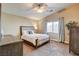 Comfortable bedroom featuring a plush bed, ceiling fan, window with curtains, and neutral wall color at 3313 Jamaica Princess Pl # 3, North Las Vegas, NV 89084