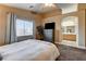 Inviting bedroom with a comfortable bed, neutral walls, ceiling fan, and access to an ensuite bathroom at 3313 Jamaica Princess Pl # 3, North Las Vegas, NV 89084