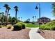 Landscaped community area with lush green spaces, palm trees, and paved pathways at 3313 Jamaica Princess Pl # 3, North Las Vegas, NV 89084