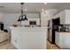 Open-concept kitchen featuring white cabinets, stainless steel appliances, and breakfast bar at 3313 Jamaica Princess Pl # 3, North Las Vegas, NV 89084