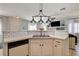 Kitchen island with sink and breakfast bar offering additional seating at 3313 Jamaica Princess Pl # 3, North Las Vegas, NV 89084