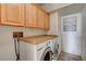 Bright laundry room boasts modern washer and dryer, tiled floor, and plenty of cabinet space at 3313 Jamaica Princess Pl # 3, North Las Vegas, NV 89084